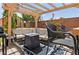 Backyard patio area complete with a pergola, outdoor seating, and a fire pit for entertaining at 2079 Port Royal Dr, Laughlin, NV 89029