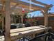 Backyard patio area complete with a pergola, bar seating, and an outdoor dining space at 2079 Port Royal Dr, Laughlin, NV 89029