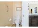 Cozy bathroom featuring a toilet and vanity with granite counters in a well-lit space at 2079 Port Royal Dr, Laughlin, NV 89029