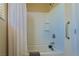 Clean bathroom featuring a shower-tub combination with white tiling and a grab bar at 2079 Port Royal Dr, Laughlin, NV 89029