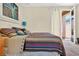 Comfortable bedroom featuring a colorful striped blanket and direct access to a private patio at 2079 Port Royal Dr, Laughlin, NV 89029