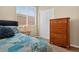 Comfortable bedroom with a large window, wooden dresser and sliding door closet at 2079 Port Royal Dr, Laughlin, NV 89029