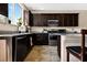 The kitchen features granite countertops, stainless steel appliances, and dark cabinetry offering a modern cooking space at 2079 Port Royal Dr, Laughlin, NV 89029