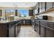 Modern kitchen boasting dark cabinetry, granite countertops, stainless steel appliances, and plenty of natural light at 2079 Port Royal Dr, Laughlin, NV 89029