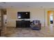 Open living area with tile floors and a large TV; great for entertainment and comfortable living at 2079 Port Royal Dr, Laughlin, NV 89029