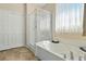 Bright main bathroom featuring a soaking tub with a glass-enclosed shower and a separate toilet room at 2079 Port Royal Dr, Laughlin, NV 89029