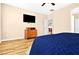 Spacious main bedroom with hardwood floors, ceiling fan, dresser and a television at 2079 Port Royal Dr, Laughlin, NV 89029