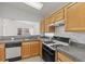 Bright kitchen featuring wooden cabinetry, granite countertops, and modern appliances at 2154 Eagle Sticks Dr, Henderson, NV 89012