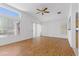 Bright and open living room featuring laminate wood flooring, large windows, and natural light at 2154 Eagle Sticks Dr, Henderson, NV 89012