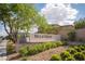 Bella Verdi community entrance featuring a stone sign, lush landscaping, and inviting curb appeal at 2198 Maderno St, Henderson, NV 89044
