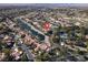 Beautiful aerial view of a luxury home surrounded by lush greenery, a lake, and a golf course at 2200 Glenbrook Way, Las Vegas, NV 89117