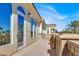 Expansive covered balcony with ornate railing and stunning lake and neighborhood views at 2200 Glenbrook Way, Las Vegas, NV 89117