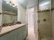 Elegant bathroom features a glass enclosed shower, vanity, and a walk-through to another room at 2200 Glenbrook Way, Las Vegas, NV 89117