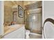 Cozy bathroom featuring a walk-in shower, vanity with sink, and neutral colored tile at 2200 Glenbrook Way, Las Vegas, NV 89117
