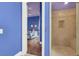 Hallway view of a bedroom on the left, and bathroom with tile shower on the right at 2200 Glenbrook Way, Las Vegas, NV 89117