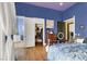 Bedroom featuring walk-in closet, dresser, hardwood floors, and blue walls at 2200 Glenbrook Way, Las Vegas, NV 89117