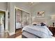 Beautiful bedroom with cloud painted ceiling, a large bed, and mirrored closet doors at 2200 Glenbrook Way, Las Vegas, NV 89117