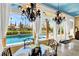 Bright dining area features pool view and elegant chandeliers at 2200 Glenbrook Way, Las Vegas, NV 89117