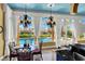 Elegant dining area with a pool view, hanging chandeliers, and marble floors at 2200 Glenbrook Way, Las Vegas, NV 89117