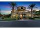 Charming two-story home featuring a grand entrance, lush landscaping, and a circular driveway at 2200 Glenbrook Way, Las Vegas, NV 89117