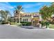 Stunning two-story home featuring a grand facade, lush landscaping, and a circular driveway at 2200 Glenbrook Way, Las Vegas, NV 89117