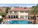 Elegant estate showcasing a spacious pool, balconies, and lush landscaping at 2200 Glenbrook Way, Las Vegas, NV 89117