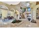An expansive foyer with staircase, sculpture, dining set and marble floors creates a luxurious ambiance at 2200 Glenbrook Way, Las Vegas, NV 89117