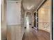 Long hallway featuring hardwood floors, archways, and a built-in storage cabinet at 2200 Glenbrook Way, Las Vegas, NV 89117