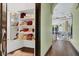 Hallway view of shelves to the left, and foyer with decorative ceilings to the right at 2200 Glenbrook Way, Las Vegas, NV 89117