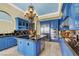 Spacious kitchen featuring custom blue cabinets, stainless steel appliances, and a stylish chandelier at 2200 Glenbrook Way, Las Vegas, NV 89117