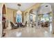 Spacious living room boasts elegant arches, pillars, a chandelier, and comfortable seating area at 2200 Glenbrook Way, Las Vegas, NV 89117