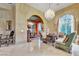 Elegant living room featuring a chandelier, fireplace, and plush seating, perfect for relaxation at 2200 Glenbrook Way, Las Vegas, NV 89117