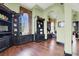 Elegant living room featuring hardwood floors, built-in shelving, and bright natural light from large windows at 2200 Glenbrook Way, Las Vegas, NV 89117