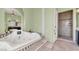 Luxurious jacuzzi tub and walk-in shower featuring tile work and natural light at 2200 Glenbrook Way, Las Vegas, NV 89117