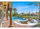 Covered patio overlooking the inviting pool and spa, a perfect spot for entertaining at 2200 Glenbrook Way, Las Vegas, NV 89117
