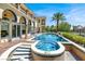 Tranquil pool area with a luxurious spa and lush greenery, offering a serene retreat at 2200 Glenbrook Way, Las Vegas, NV 89117