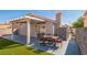 Inviting backyard featuring a covered patio, a dining table, and a charming pergola at 2229 Bowstring Dr, Las Vegas, NV 89142