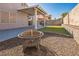 Backyard featuring a covered patio, landscaping, a rock garden, and a fire pit at 2229 Bowstring Dr, Las Vegas, NV 89142