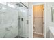 Modern glass shower in the bathroom with marble tile and black hardware at 2229 Bowstring Dr, Las Vegas, NV 89142