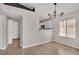 Bright dining room featuring a stylish light fixture, wood floors, and kitchen access through a small bar at 2229 Bowstring Dr, Las Vegas, NV 89142