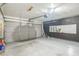Large two-car garage featuring epoxy flooring, insulated garage door and a utility access at 2229 Bowstring Dr, Las Vegas, NV 89142