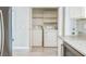 Laundry room including white washer, dryer and shelving at 2229 Bowstring Dr, Las Vegas, NV 89142