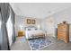 Bright bedroom with a large window, features wood-look floors, and a comfortable king bed with stylish accents at 2404 Elmont Ave, North Las Vegas, NV 89086