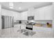 Bright kitchen with white cabinets, stainless appliances, granite counters, and a double basin sink at 2404 Elmont Ave, North Las Vegas, NV 89086