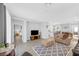 Bright open-concept living area with a comfortable furniture set and view of the kitchen at 2404 Elmont Ave, North Las Vegas, NV 89086