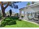 Backyard with pergola covered patio, artificial grass, and views of the pool and tennis court at 2496 Ram Crossing Way, Henderson, NV 89074