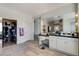 Bright bathroom with a vanity area, a walk-in closet, and stylish lighting at 2496 Ram Crossing Way, Henderson, NV 89074