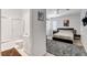 This bedroom shows a connection with the bathroom, which is tiled and has a sliding glass door at 2496 Ram Crossing Way, Henderson, NV 89074