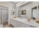 Bathroom featuring double sinks, neutral color scheme, and decorative accents at 2496 Ram Crossing Way, Henderson, NV 89074