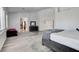 Large bedroom boasting ample natural light, plank floors, and a decorative area rug at 2496 Ram Crossing Way, Henderson, NV 89074